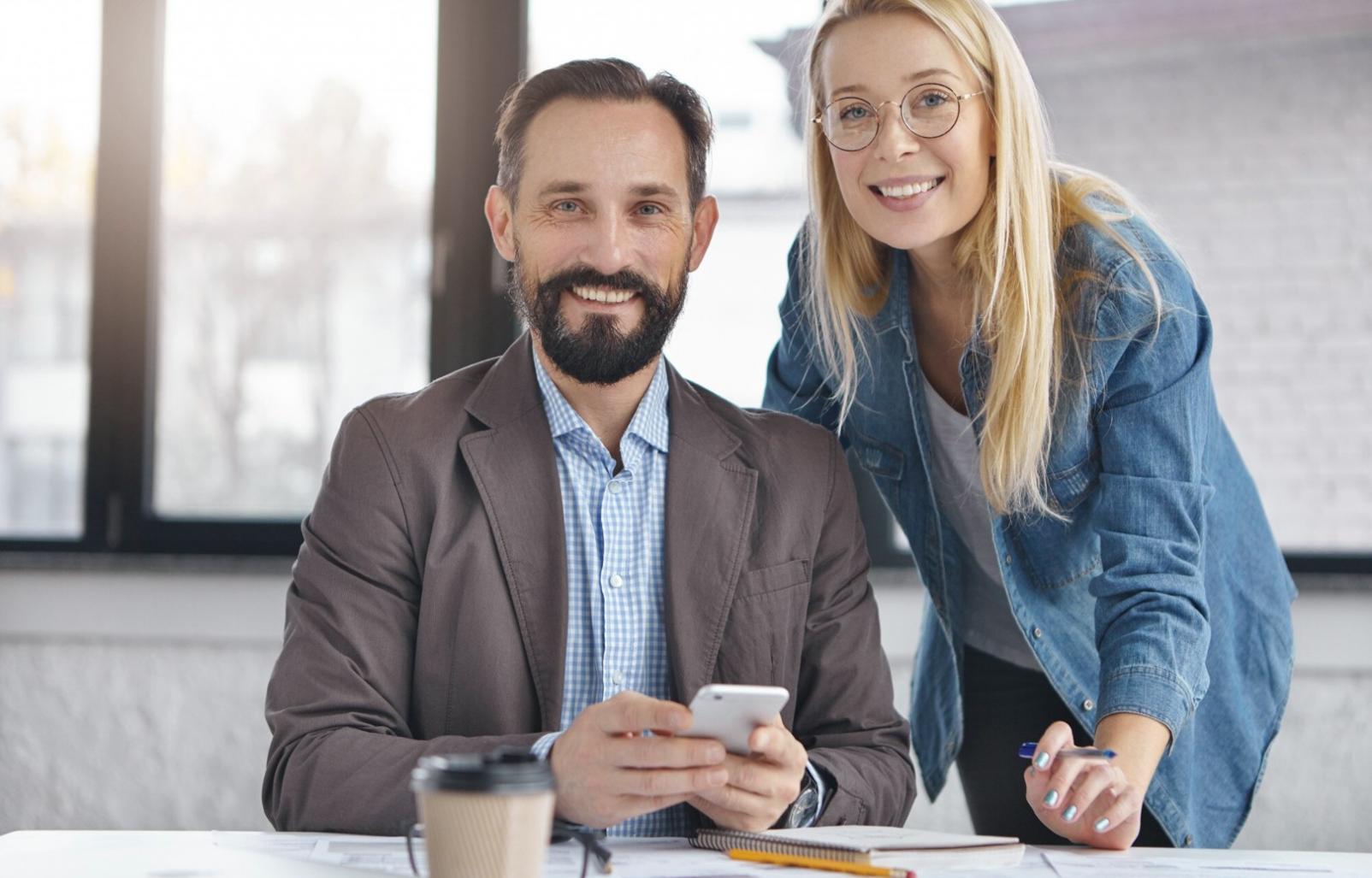 Participant analyzing recorded negotiation session with instructor providing detailed feedback on communication patterns